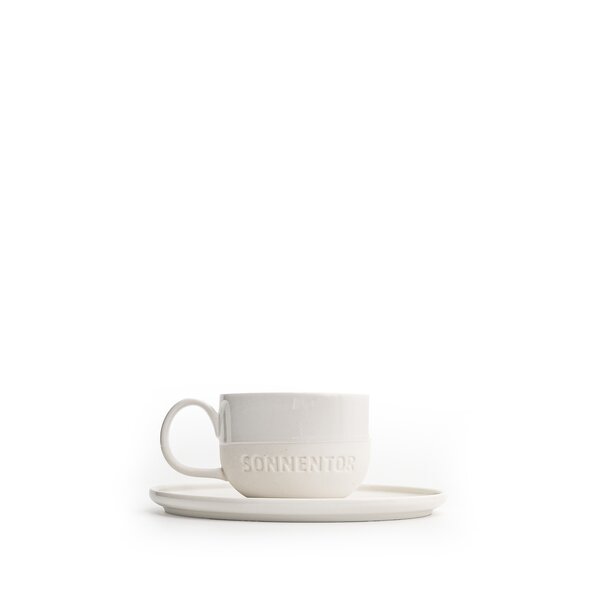 The photo shows a white SONNENTOR porcelain espresso cup with saucer and lettering. The cup holds 62.5 ml!